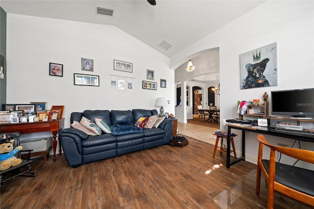 living room featuring hardwood / wood-style flooring and vaulted ceiling