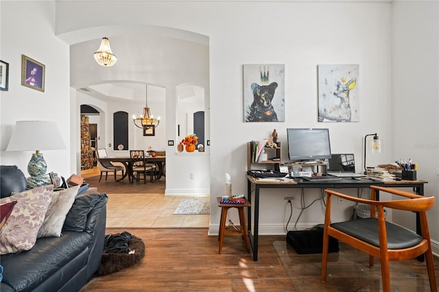 office area featuring hardwood / wood-style floors and a chandelier