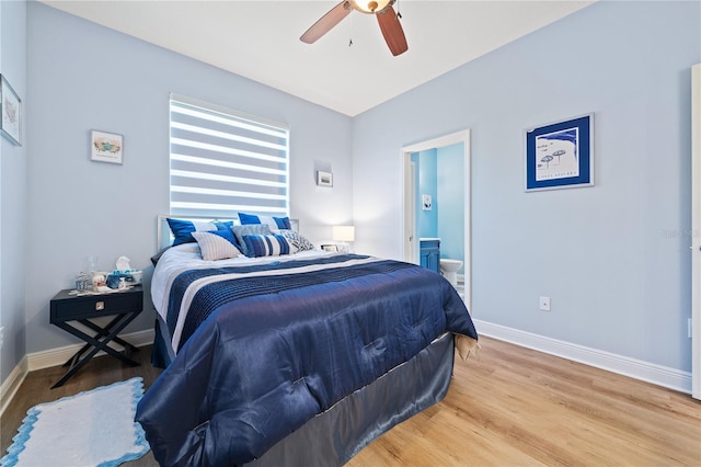 bedroom with ceiling fan, ensuite bathroom, and hardwood / wood-style floors