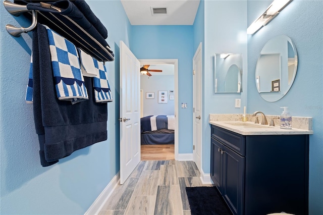 bathroom with vanity, hardwood / wood-style flooring, and ceiling fan