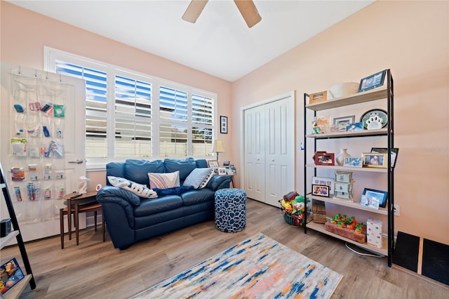 living area with light hardwood / wood-style floors and ceiling fan