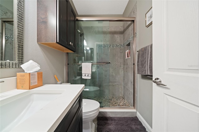 bathroom with toilet, an enclosed shower, and vanity