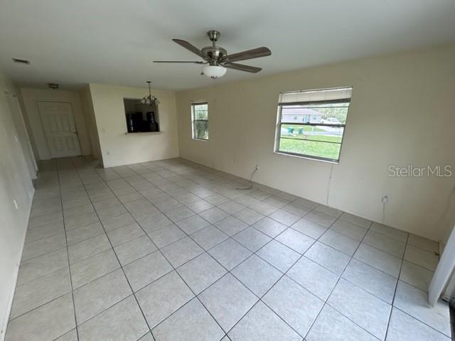 354 Camillia Ln Unit B, Port Charlotte, FL 33954 - spare room with light tile patterned floors and ceiling fan