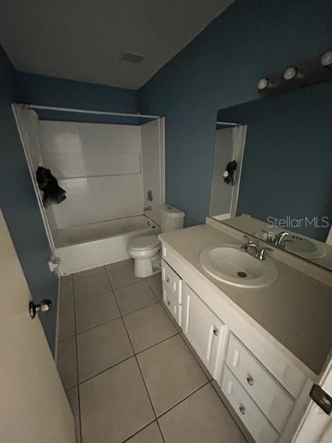 354 Camillia Ln Unit B, Port Charlotte, FL 33954 - bathroom featuring tile patterned floors, vanity, washtub / shower combination, and toilet