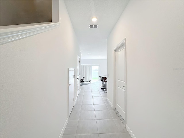 corridor with light tile patterned flooring