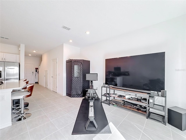 exercise room featuring light tile patterned floors