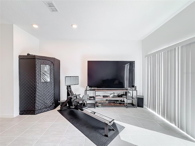 exercise room with light tile patterned floors