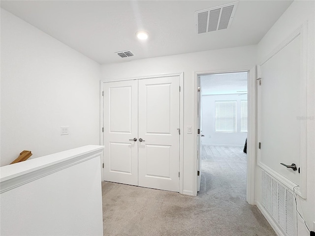 hallway with light colored carpet