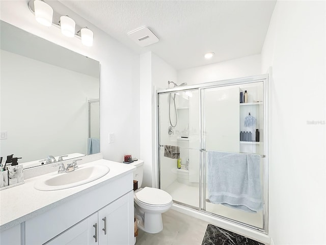 bathroom with a shower with door, a textured ceiling, concrete flooring, toilet, and vanity