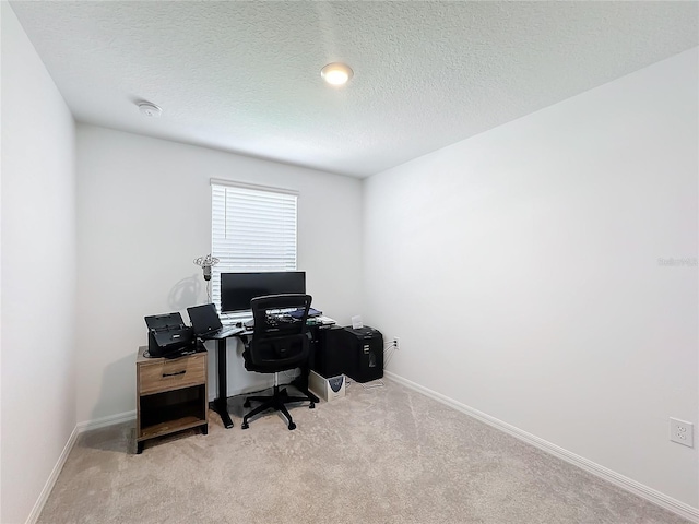 office featuring a textured ceiling and light colored carpet