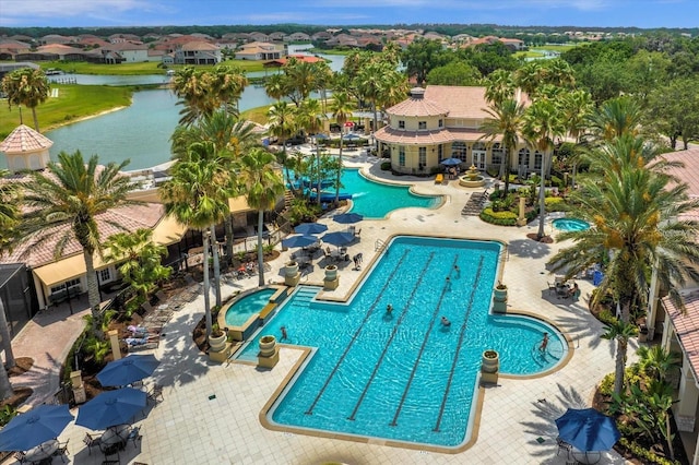 view of pool featuring a water view and a patio