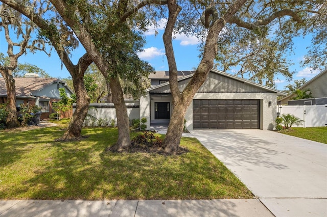 view of front of property with a front yard and a garage