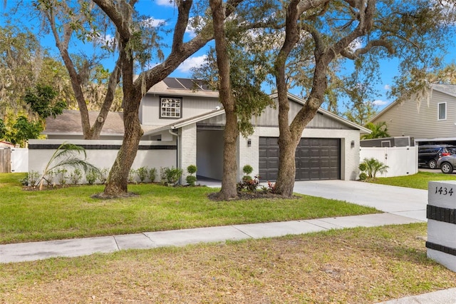 view of front facade featuring a garage and a front lawn