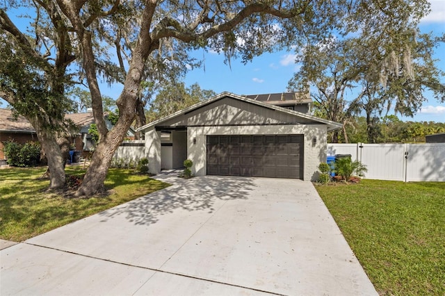 view of front facade featuring a front lawn and a garage