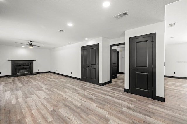 unfurnished living room with light hardwood / wood-style flooring and ceiling fan