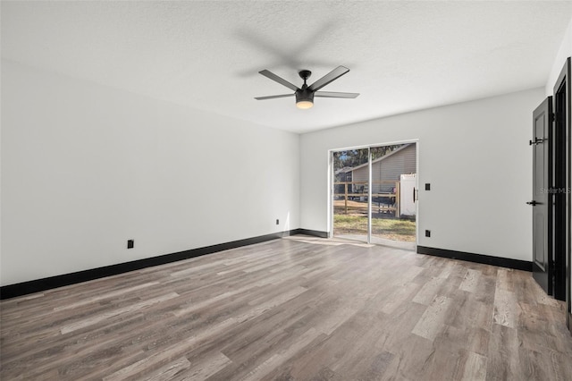 unfurnished room featuring light hardwood / wood-style flooring, a textured ceiling, and ceiling fan