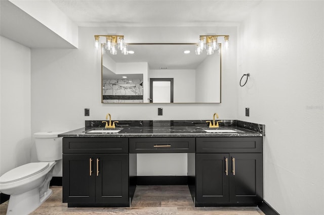 bathroom featuring vanity, hardwood / wood-style flooring, and toilet