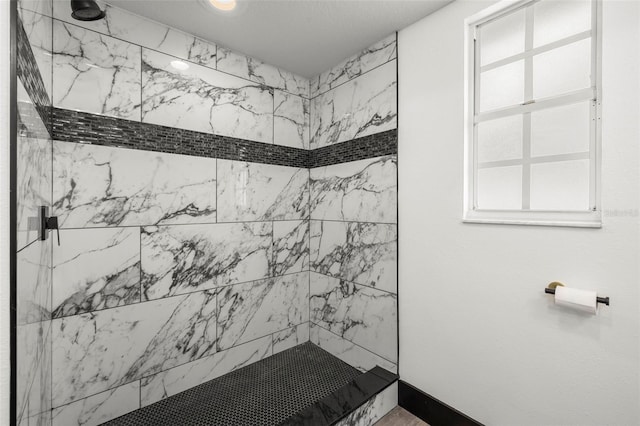 bathroom with tiled shower