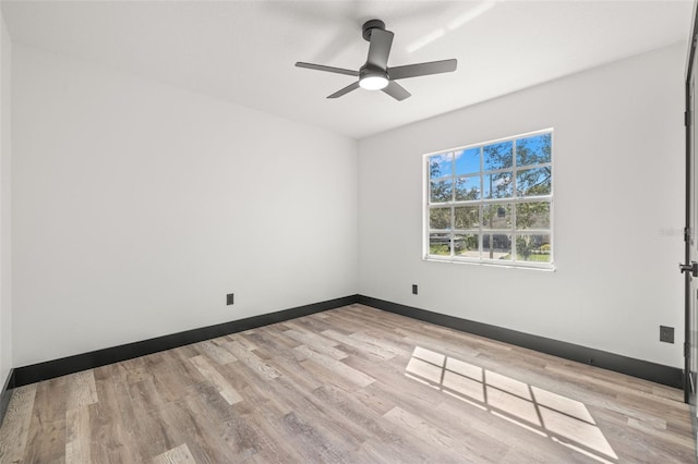 spare room featuring light hardwood / wood-style floors and ceiling fan