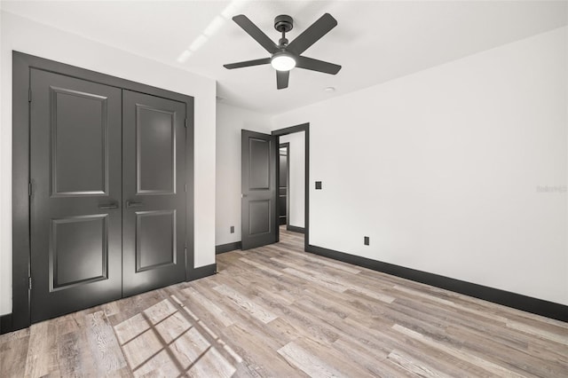 unfurnished bedroom featuring a closet, ceiling fan, and light wood-type flooring