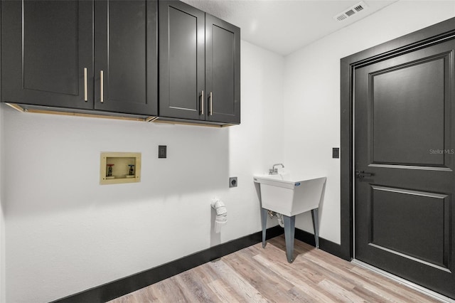 laundry area with cabinets, washer hookup, light wood-type flooring, and electric dryer hookup