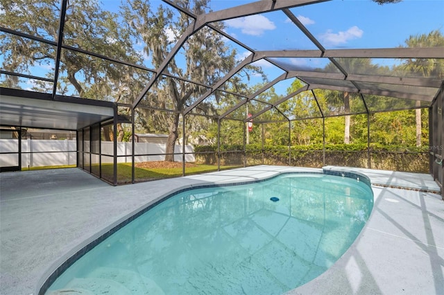 view of swimming pool with a patio area and glass enclosure