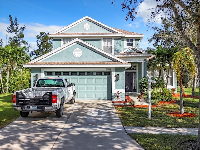 view of front facade with a garage and a front lawn