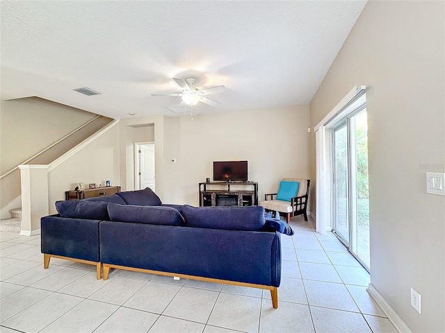 tiled living room featuring ceiling fan