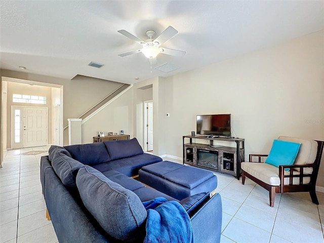 tiled living room with ceiling fan