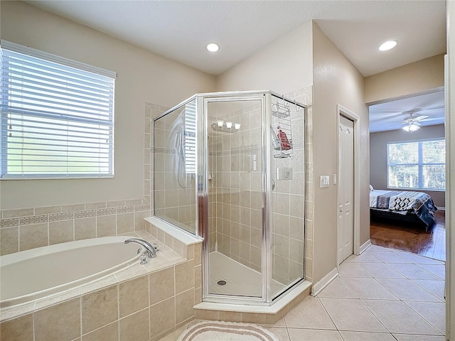 bathroom with plus walk in shower, hardwood / wood-style flooring, and ceiling fan