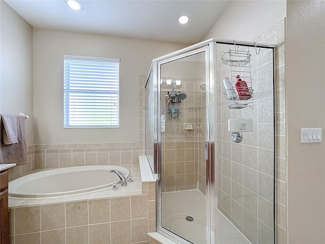 bathroom featuring vanity and independent shower and bath