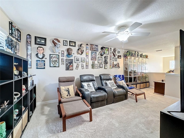 home theater with a textured ceiling, carpet flooring, and ceiling fan