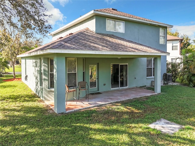 back of house with a yard and a patio area