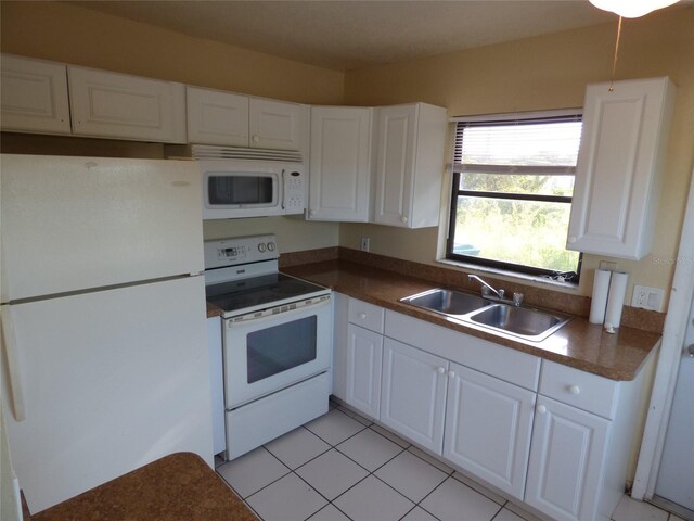 27242 Sunnybrook Rd Unit B, Punta Gorda, FL 33983 - kitchen featuring white appliances, a sink, white cabinetry, and dark countertops
