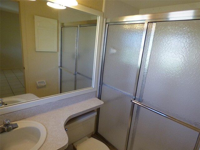 27242 Sunnybrook Rd Unit B, Punta Gorda, FL 33983 - bathroom featuring a shower with shower door, vanity, and toilet
