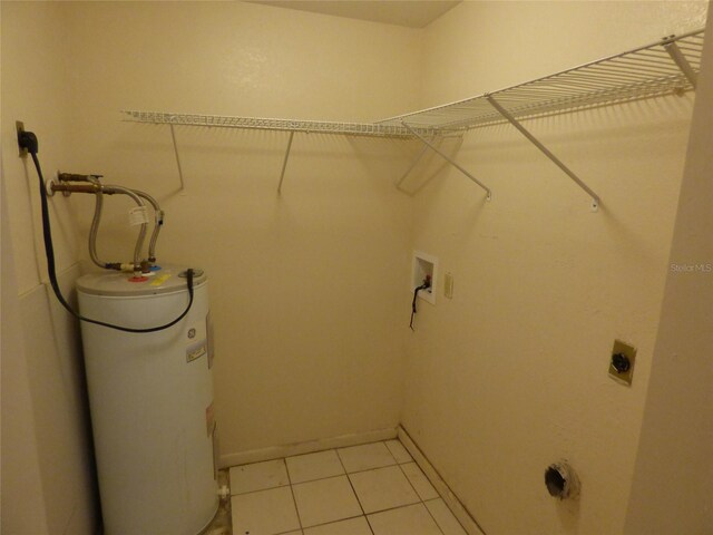 27242 Sunnybrook Rd Unit B, Punta Gorda, FL 33983 - laundry area with hookup for an electric dryer, electric water heater, washer hookup, baseboards, and light tile patterned floors