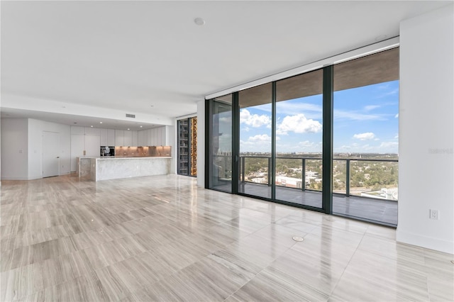 2912 W Santiago St Unit 1901, Tampa, FL 33629 - unfurnished living room with a wall of windows and baseboards