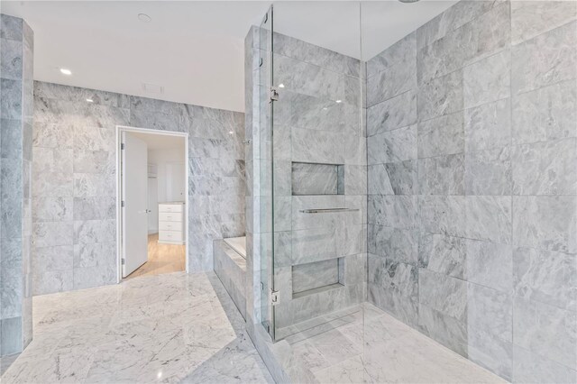 bathroom with separate shower and tub and tile walls