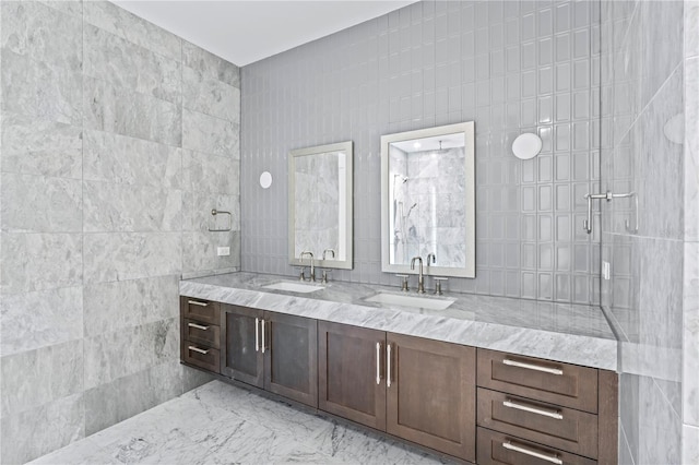 bathroom with vanity, tile walls, and tiled shower