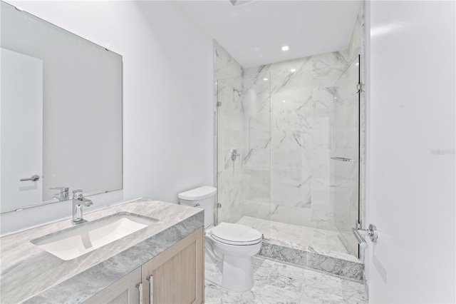 bathroom with an enclosed shower, vanity, and toilet