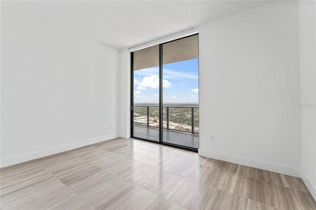 empty room featuring a wall of windows