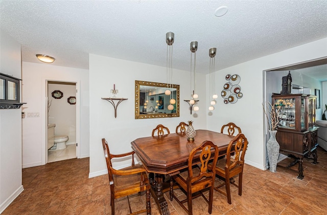 dining area with a textured ceiling