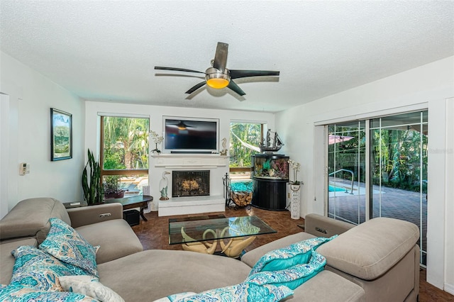 13191 92nd Ave, Seminole, FL 33776 - living area featuring plenty of natural light, ceiling fan, a fireplace with raised hearth, and a textured ceiling