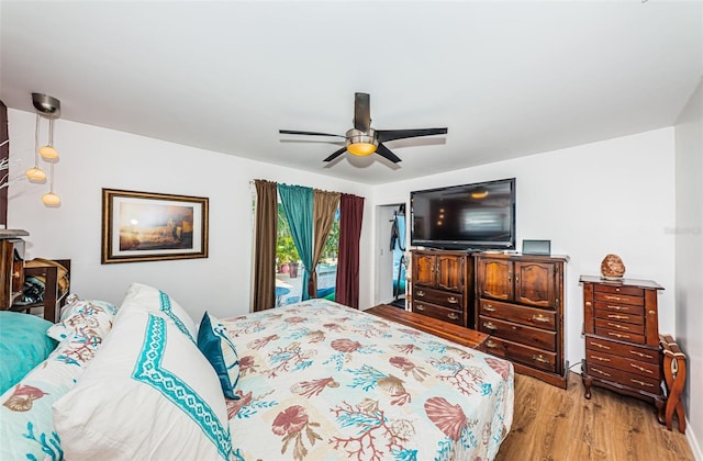 bedroom featuring access to outside, ceiling fan, and light wood-type flooring