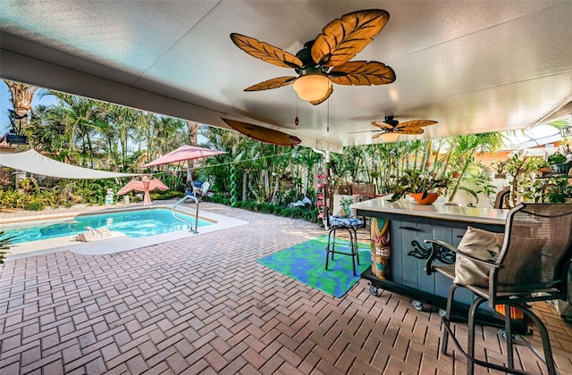 view of swimming pool with ceiling fan and a patio area