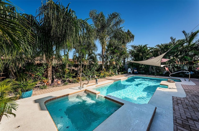 view of swimming pool featuring an in ground hot tub