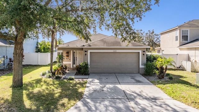 view of front of home with a front yard and a garage