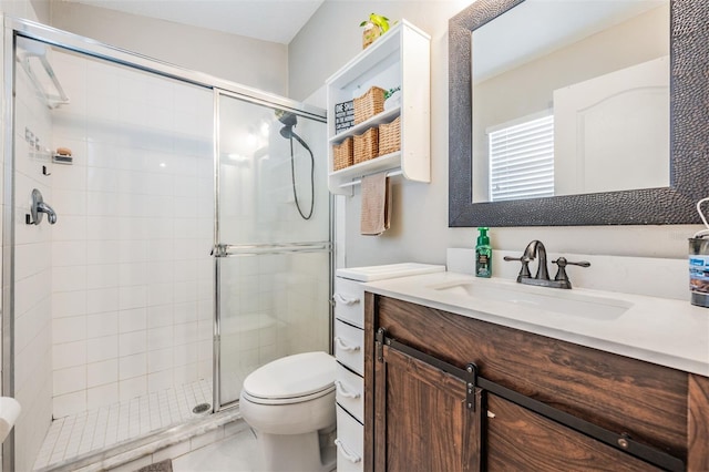 bathroom with vanity, toilet, and a shower with door