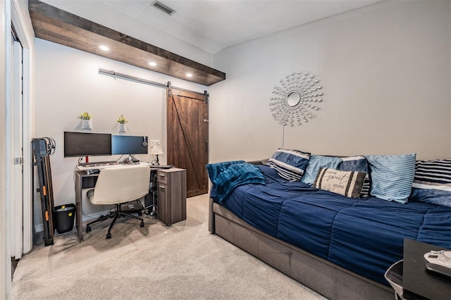 carpeted bedroom with a barn door