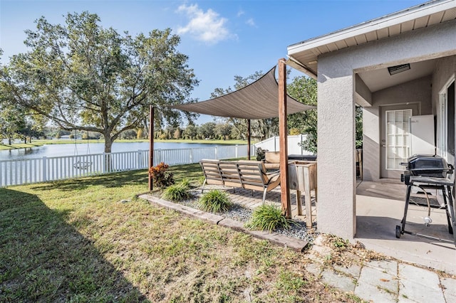 view of yard with a patio area, an outdoor living space, and a water view